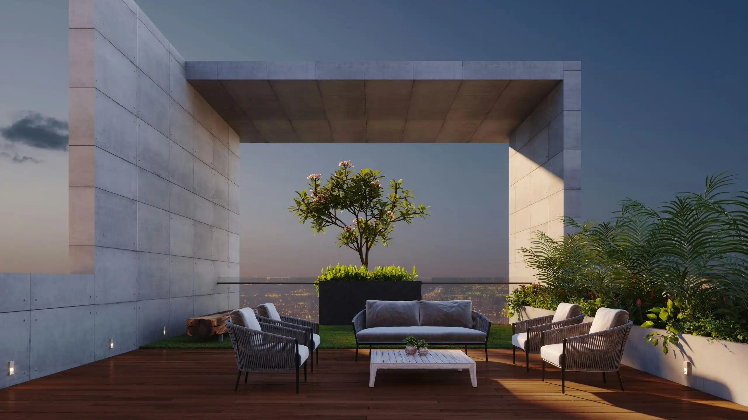 A rooftop terrace at dusk under a concrete frame: outdoor sofas on a timber deck, a small tree in a planter, a city skyline beyond