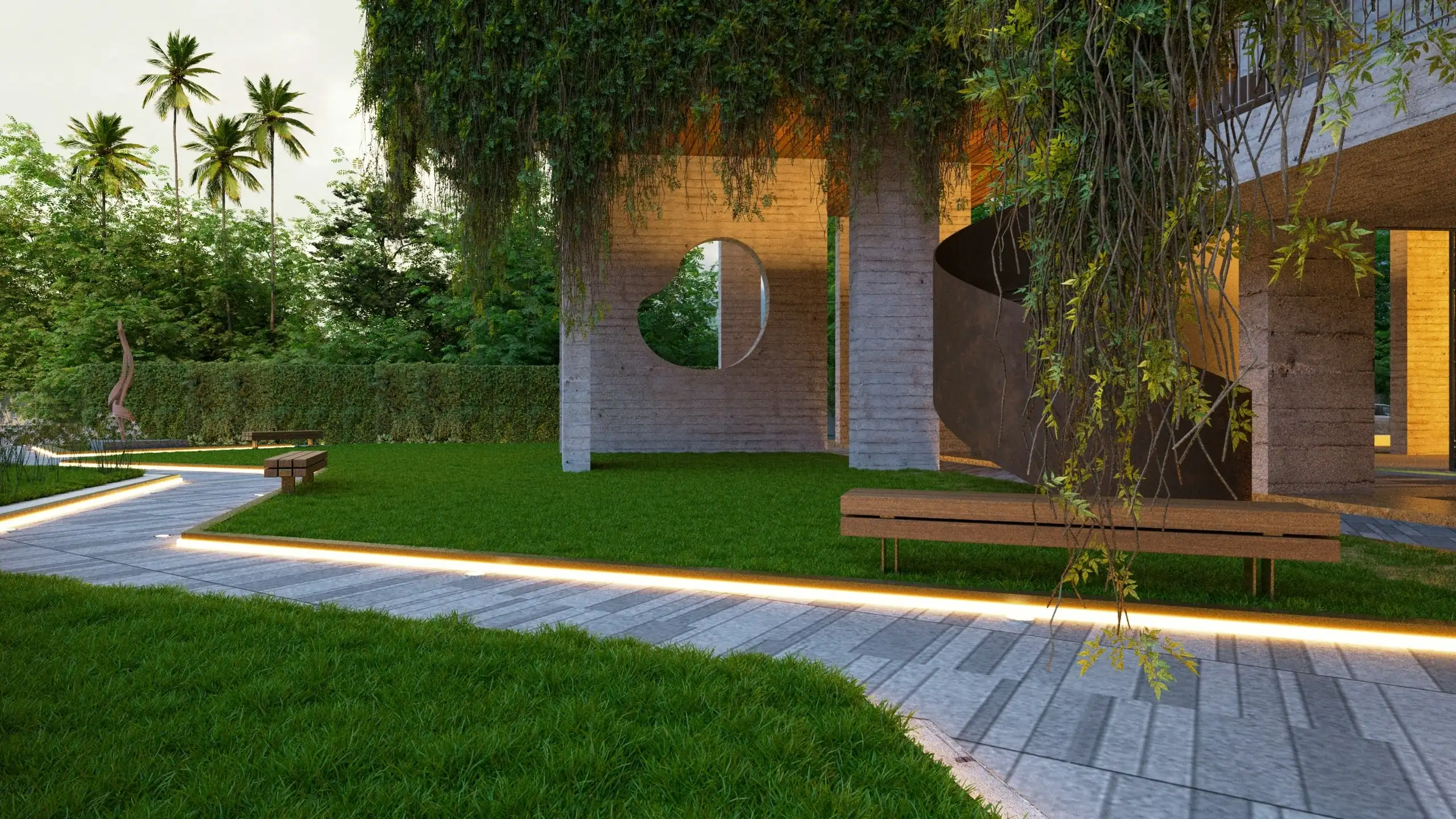 A garden at dusk: a lit path through a lawn, past a pale brick wall with a round window and vines spilling over it
